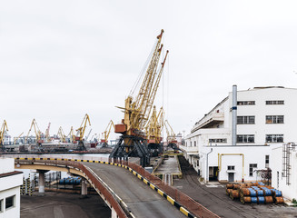 Fototapeta na wymiar Sea port with cranes and docks early in the morning
