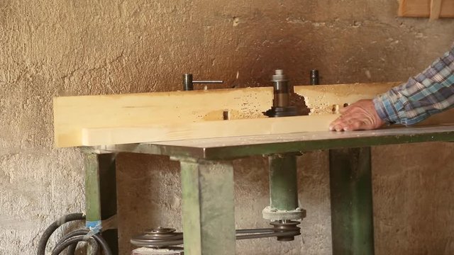 Gouging the wooden square beam on machine