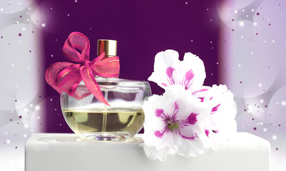  bottle of perfume, violets, on a pink background