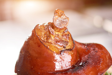 Large piece of appetizing lamb shank. Close up of roasted shank of lamb. Cooked meat at restaurant.