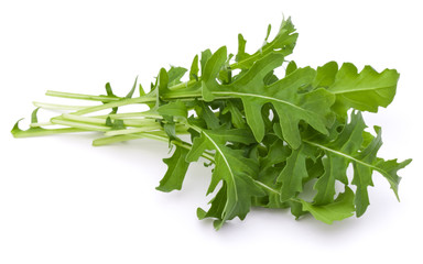 Close up studio shot of green fresh rucola leaves isolated on white background. Rocket salad or...