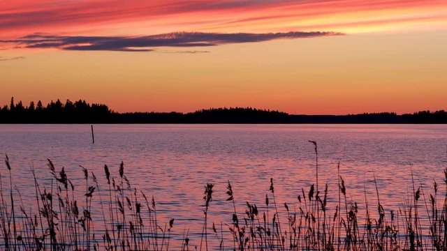 Crimson sunset on the background of the Gulf of Bothnia