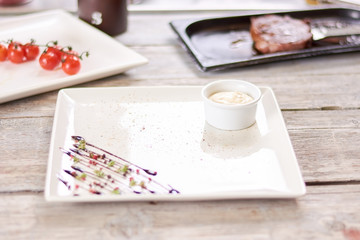 White sauce for grilled steak. Tasty cream for meat at restaurant kitchen. European cuisine and culinary.