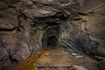 Old abandoned underground ore mica  mine shaft tunnel