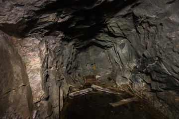 Old abandoned underground ore mica  mine shaft tunnel