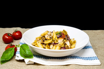 Pasta with pesto sauce and nuts on a the table