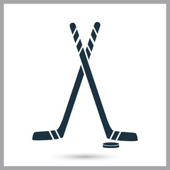 Hockey stick and puck simple icon