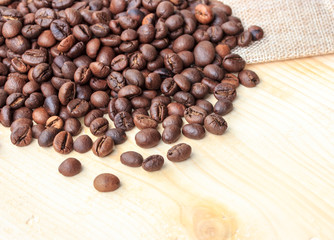 Roasted coffee beans on wooden background
