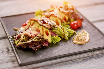 Appetizing salad with eel and avocado. Green salad made with sea eel, avocado and served with nut sauce. Delicious japanese cuisine.