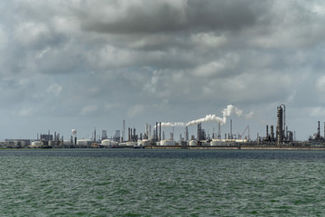 Fototapeta premium Smoke buring off an oil refinery on the gulf coast 