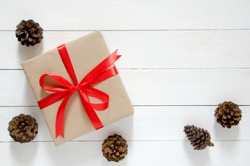 Christmas holidays and Happy New Year background. Gift boxes with red ribbon and Christmas decoration on wooden table.
