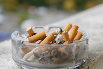 Cigarette butts in astray closeup