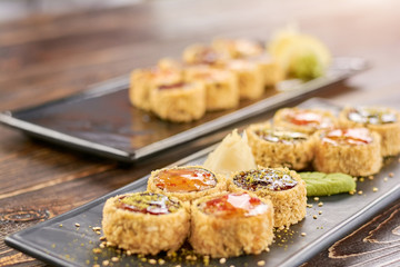 Sushi roll set at sushi bar. Delicious japanese sushi set. Appetizing unagi sushi rolls on traditional japanese dish.