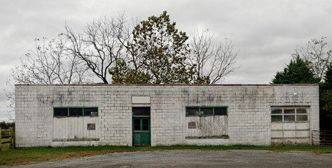 Fototapeta na wymiar Vintage rural abandoned gas station garage.