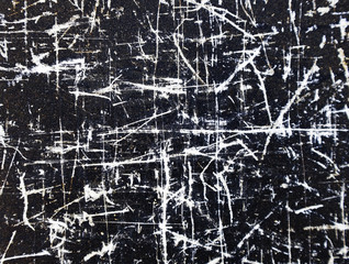 Mysterious lines etched on black surface.