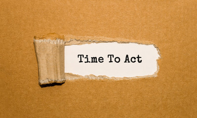 The text Time To Act appearing behind torn brown paper