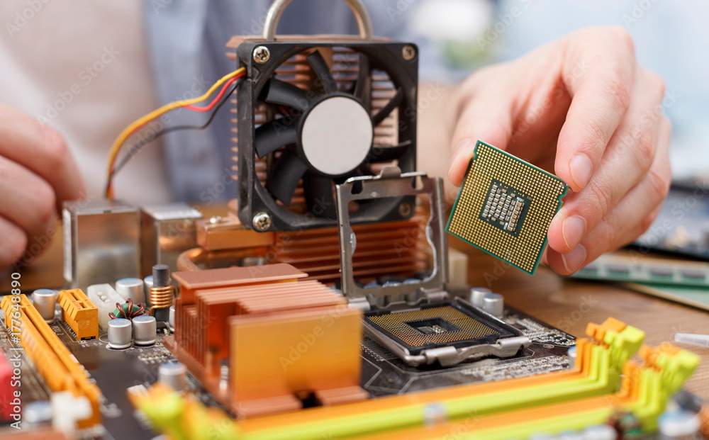 Poster technician plug in microprocessor to motherboard