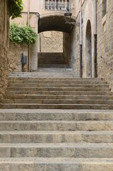 Stone stairs under  archway in Girona, Spain