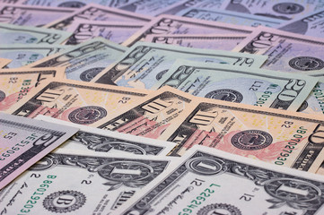 abstract money background us dollars of different denominations.