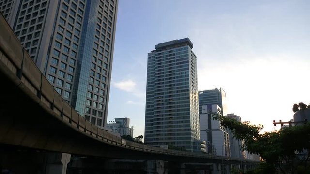 4K.Time lapse building and bridge crossing and sun and traffic in bangkok Thailand
