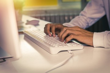 hands on the computer keyboard on the desktop