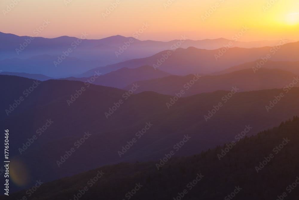 Wall mural glorious sunrise over the great smoky mountains layered blue ridges to the orange yellow horizon