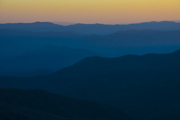 Glorious Sunrise over the Great Smoky Mountains layered blue ridges to the orange yellow horizon