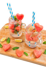Mason jars with watermelon drink on white