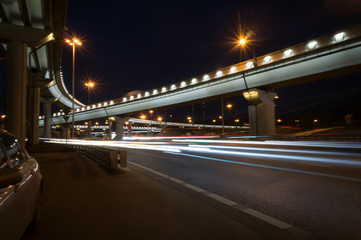 city viaduct at night in moscow. Long exposure of car lights on a freeway