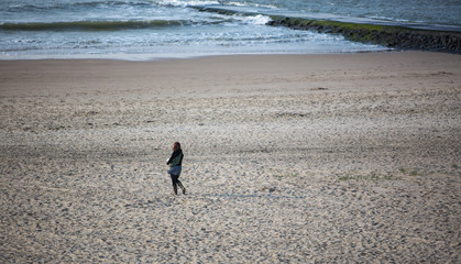 girl walking at the beach during the evening time