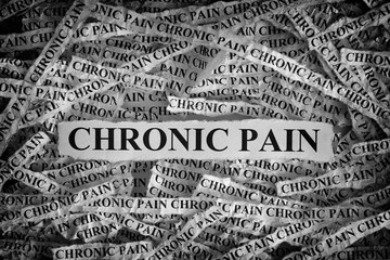Torn pieces of paper with the words Chronic Pain