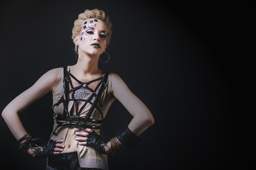 Woman beautiful model with body art of unusual and fashionable clothing in the Studio