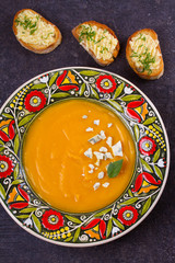 Roasted Butternut Squash Soup with Blue Cheese and Garlic Butter Toasts. Fruit and Vegetable Creamy Soup. View from above, top studio shot, vertical