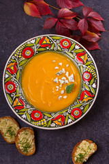 Roasted Butternut Squash Soup with Blue Cheese and Garlic Butter Toasts. Fruit and Vegetable Creamy Soup. View from above, top studio shot, vertical