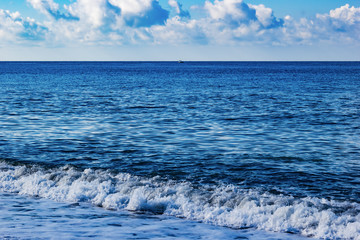 Naklejka na ściany i meble Waves of the Black sea bright blue summer seascape