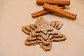 Gingerbread cookies dough, cinnamon and bakery tools. New year, Christmas, winter and cooking background
