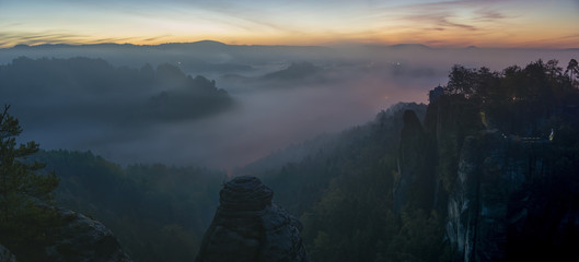 beautiful, foggy sunrise in the Saxon Saxony park, view from the Bastei lookout point.