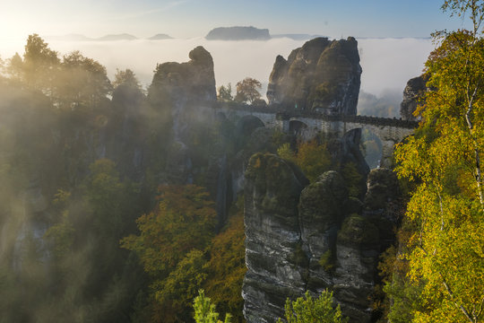 beautiful, foggy sunrise in the Saxon Saxony park, view from the Bastei lookout point.
