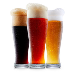 Mug collection of frosty dark red and light beer with foam isolated on a white background