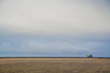 Obraz premium Endless fields of Iceland with a small house