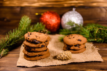 Chocolate chip cookies and christmas decorations on a wooden table