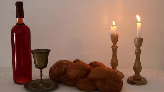 shabbat footage. challah bread, shabbat wine and candles on the table
