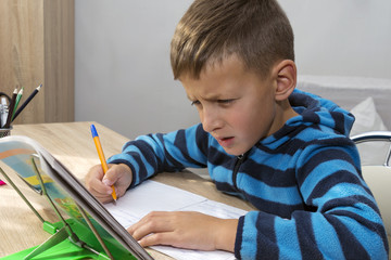 young kid, boy doing homework at home