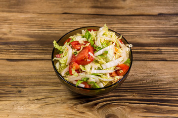 Fresh vegetable salad on wooden table