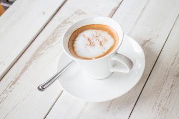 Coffee in a cup on a white wooden table