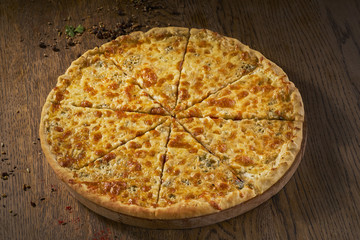 Delicious Quaddro formaggi, four cheese pizza, top view on wood background,