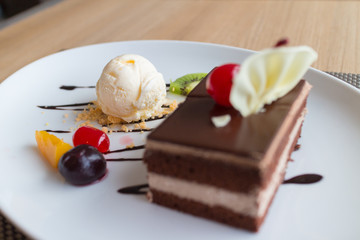 chocolate layer cake and vanilla ice cream with fresh fruit and cherry