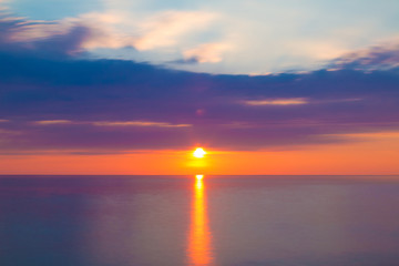 Long exposure view of the clouds and sea at sunset