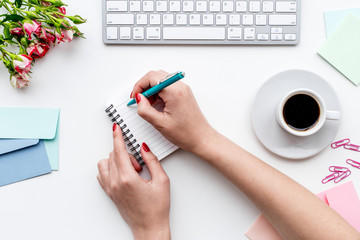 home office desk for woman with notebook, hands and flowers white background top view mock up