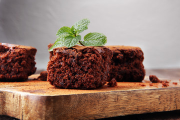 Cake chocolate brownies on wooden background with mint